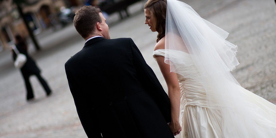 Bride and Groom walking away from their wedding ceremony in Manchester