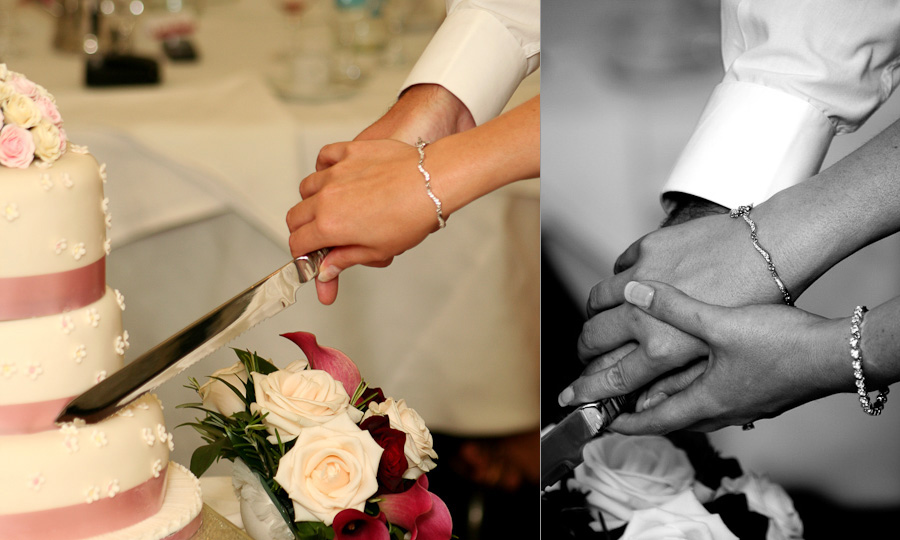 The bride and groom's hands as they cut their wedding cake