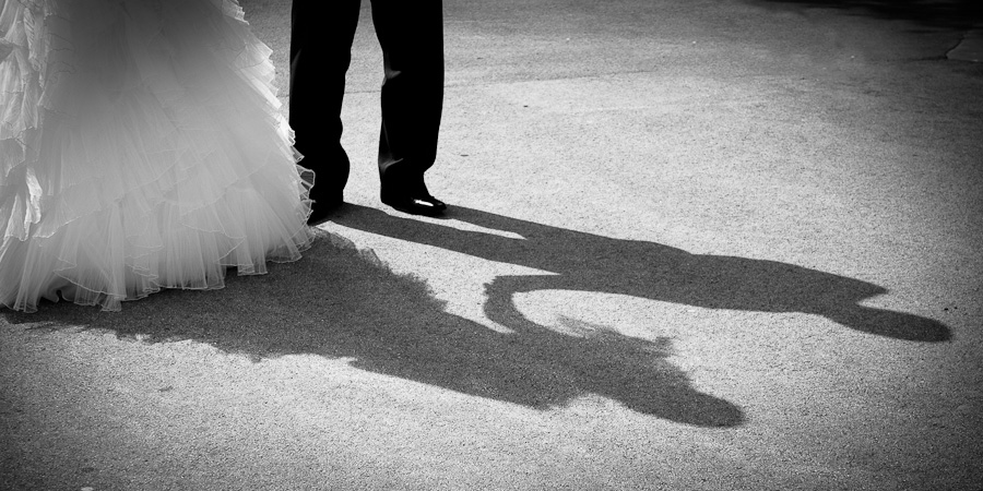 Beautifully observed wedding photograph of the bride and groom's shadows as they hold hands