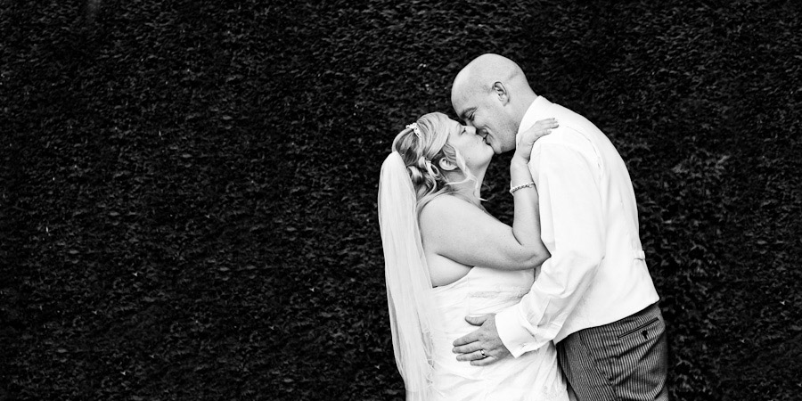 Bride and Groom embrace for a kiss in Lymm