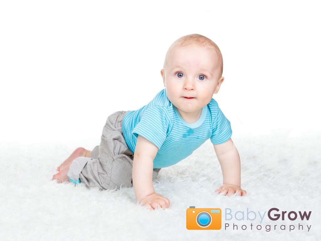 Cheeky crawling baby on white background