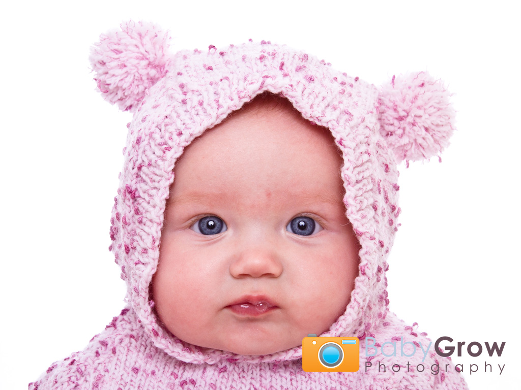 Cute baby girl in pink knitted hoodie