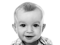 Smiling baby headshot on white background